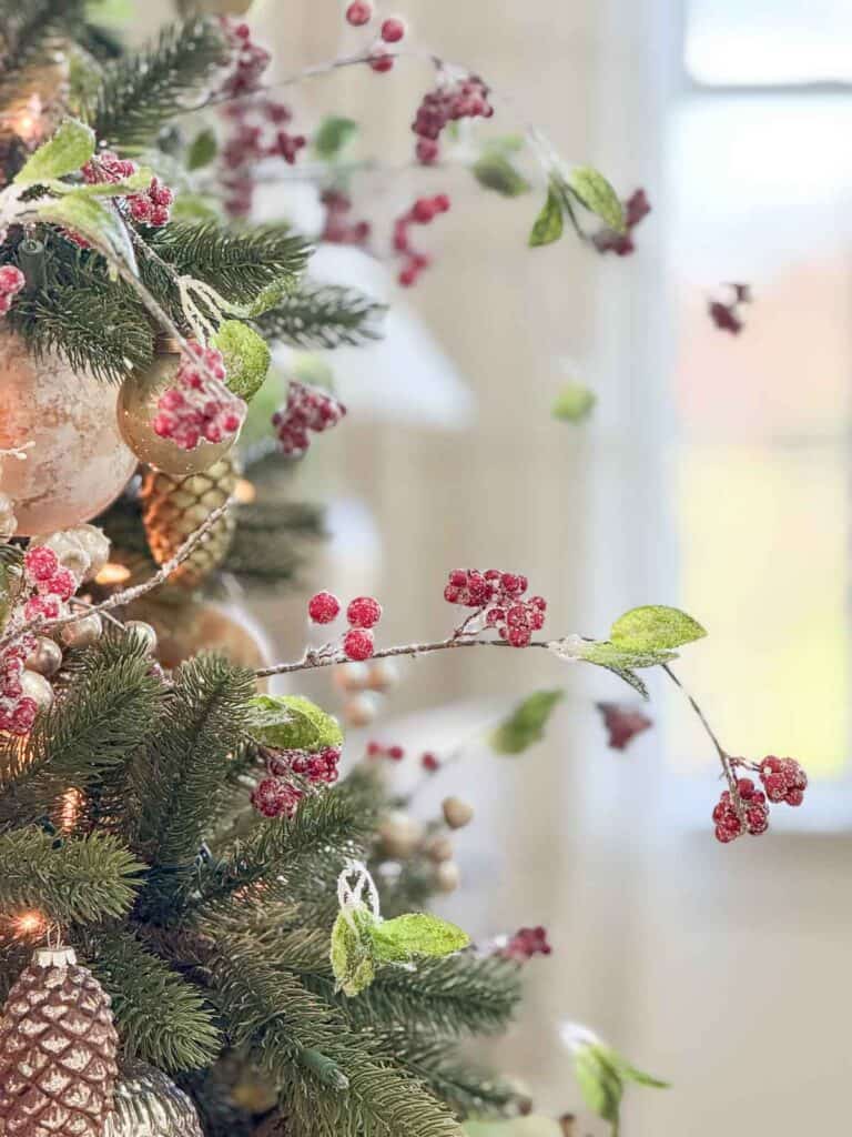berries and ornaments on a Christmas tree