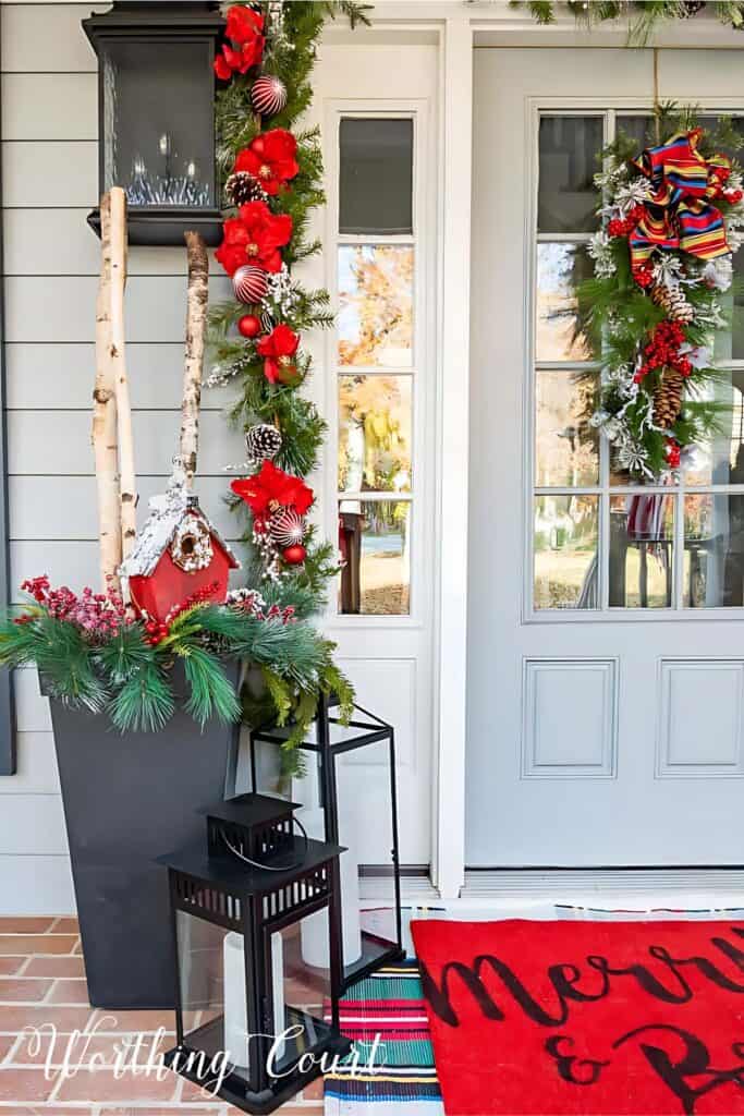 red Christmas decorations on a front porch