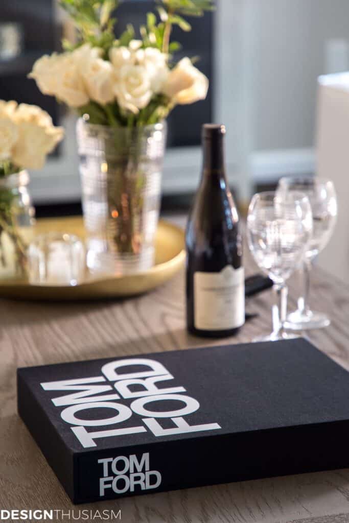 a coffee table with a bottle of champagne and a book