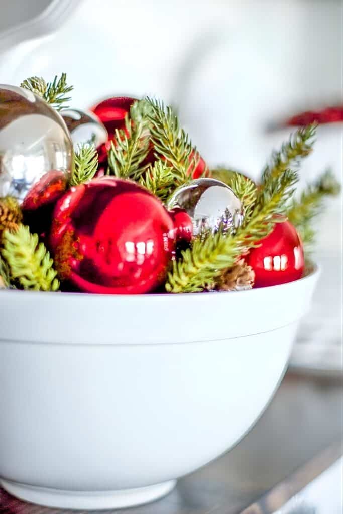 Bowl of red and silver ornaments and greens