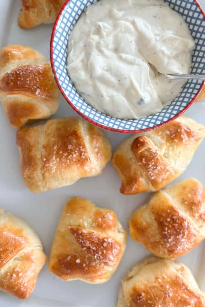 roll ups on a platter with the dipping sauce