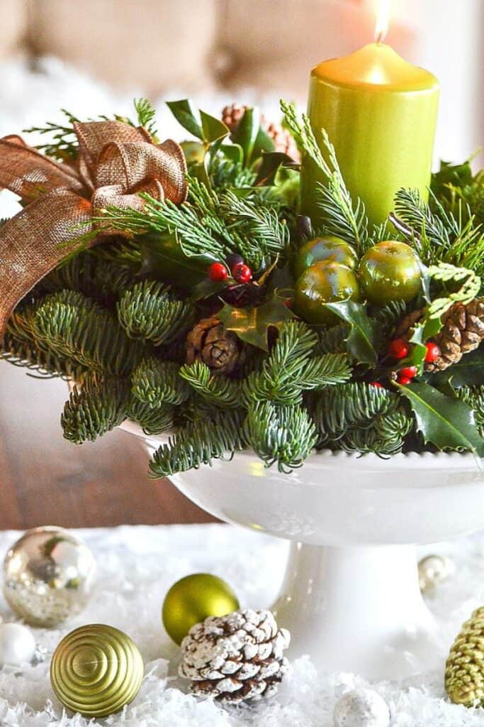 a wreath used as a candleholder and a candle in the center of it
