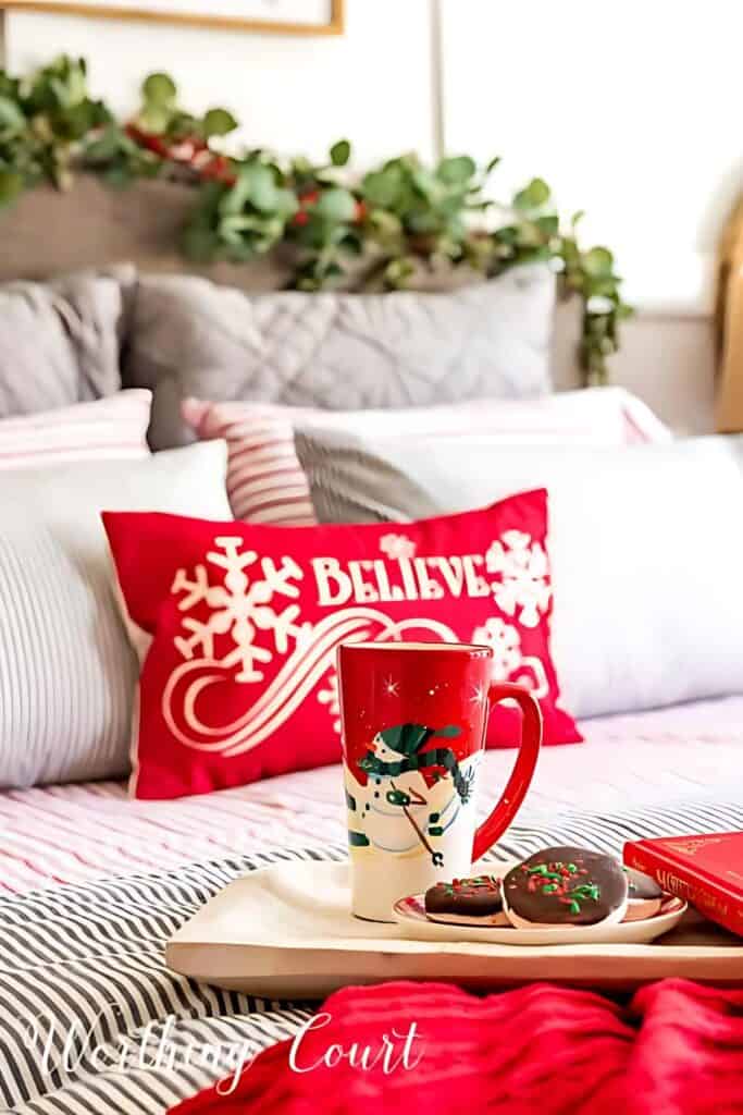 Beautiful Christmas bed with a tray of cookies and a decorative Christmas mug.