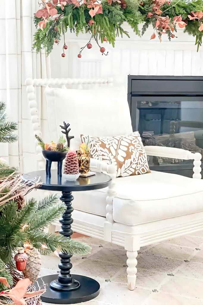 White chair surrounded by Christmas decor