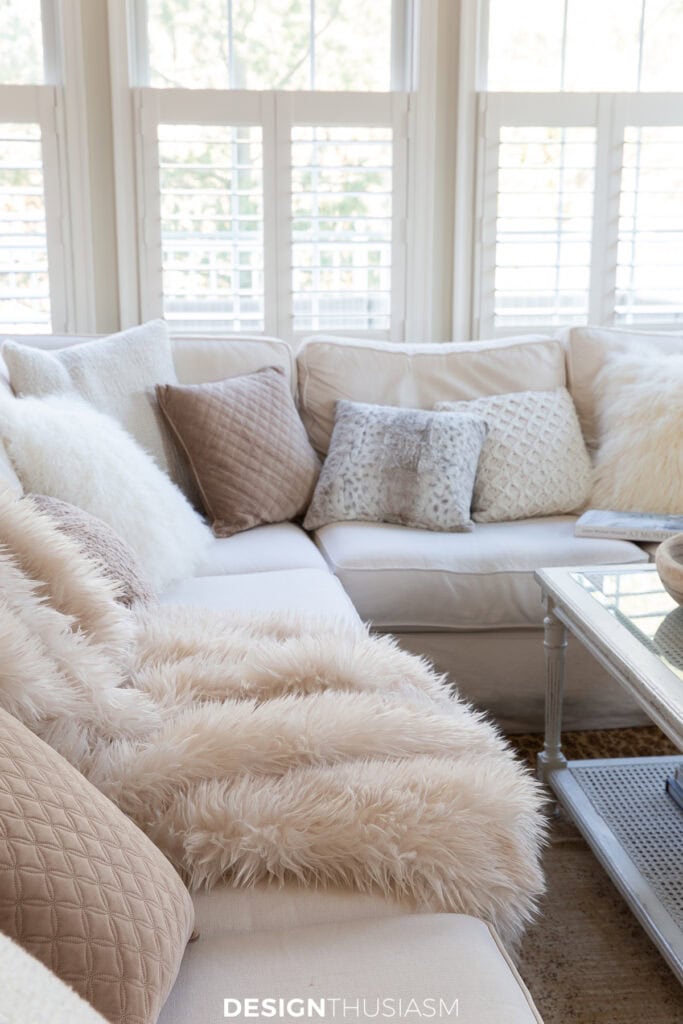 sectional with winter pillows and a faux fur throw
