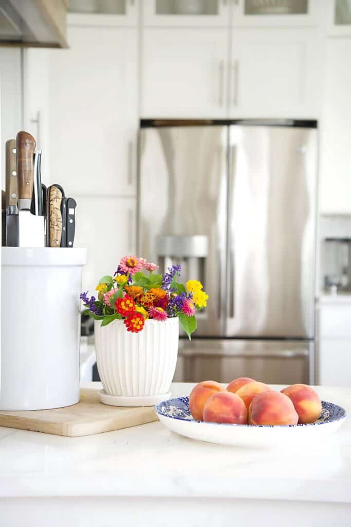 peaches and garden flowers on a counter