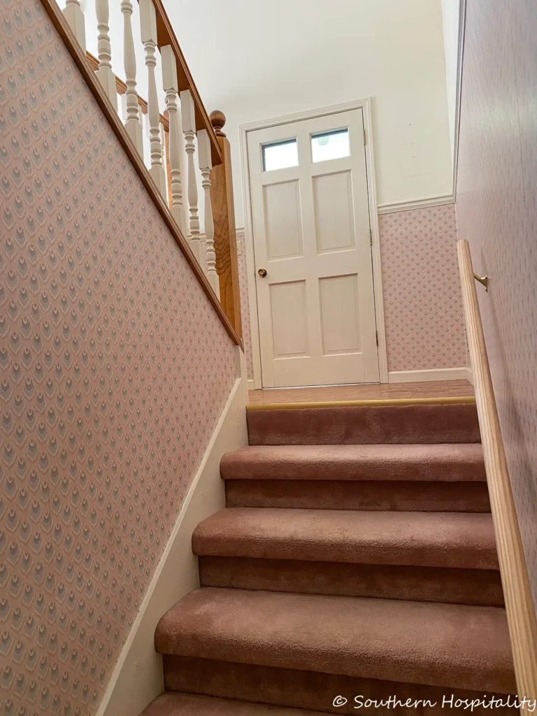 stairs with wallpaper on the walls