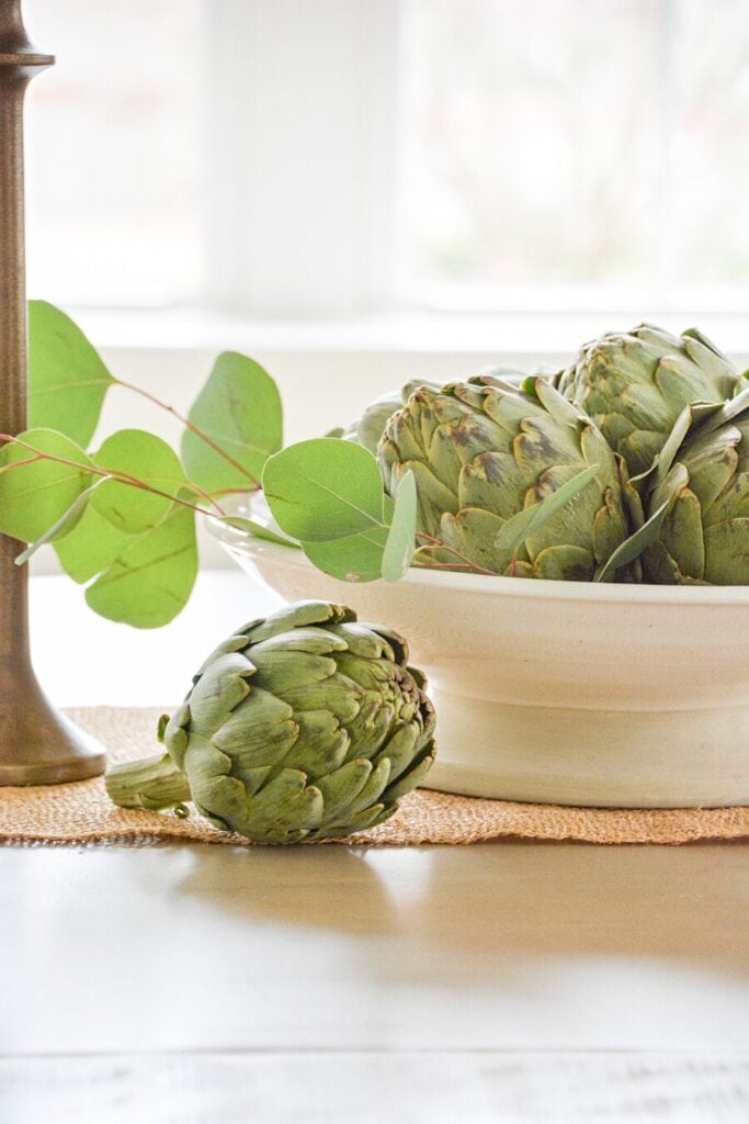 bowl of artichokes on a dining room table