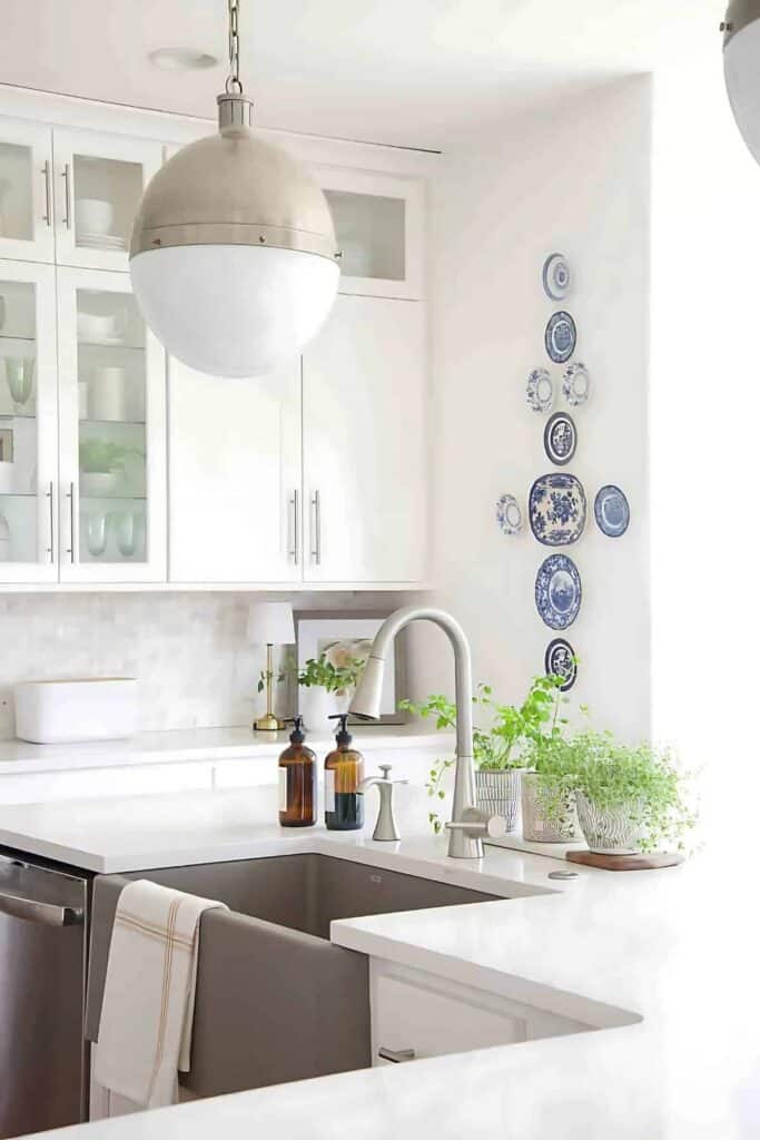 blue and white plates hanging on a kitchen wall