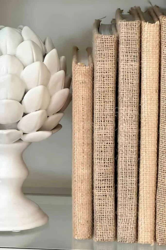 burlap books stacked upright with an artichoke bookend