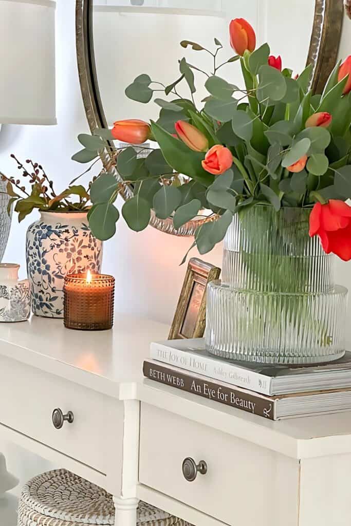 red tulips on the foyer with a scented candle