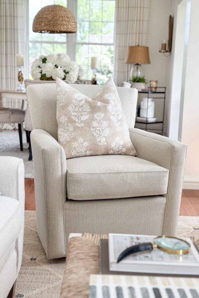 swivel chair with a neutral pillow in the living room