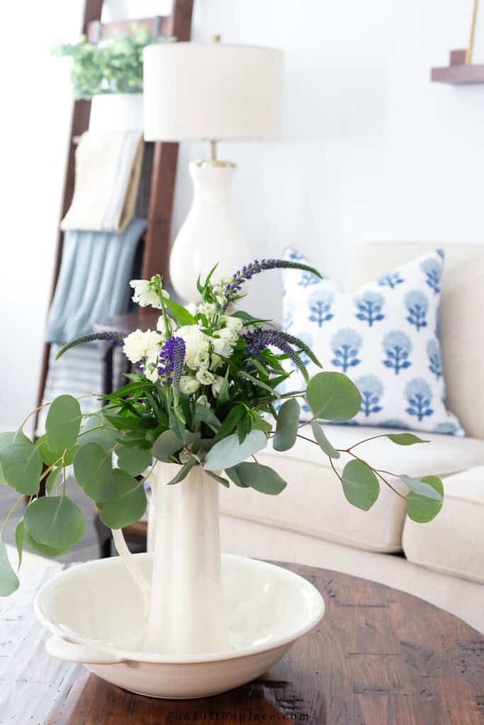 pitchers of flowers on a coffee table
