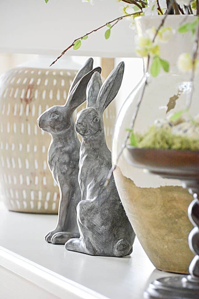simple spring decor with neutral bunny figurines on mantel