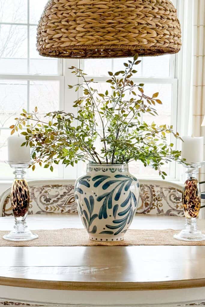 spring kitchen island decor with green branches in blue and white vase