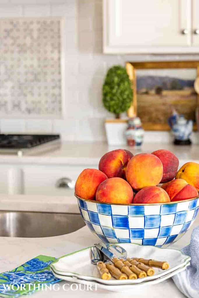 kitchen with a bowl of peaches on an island