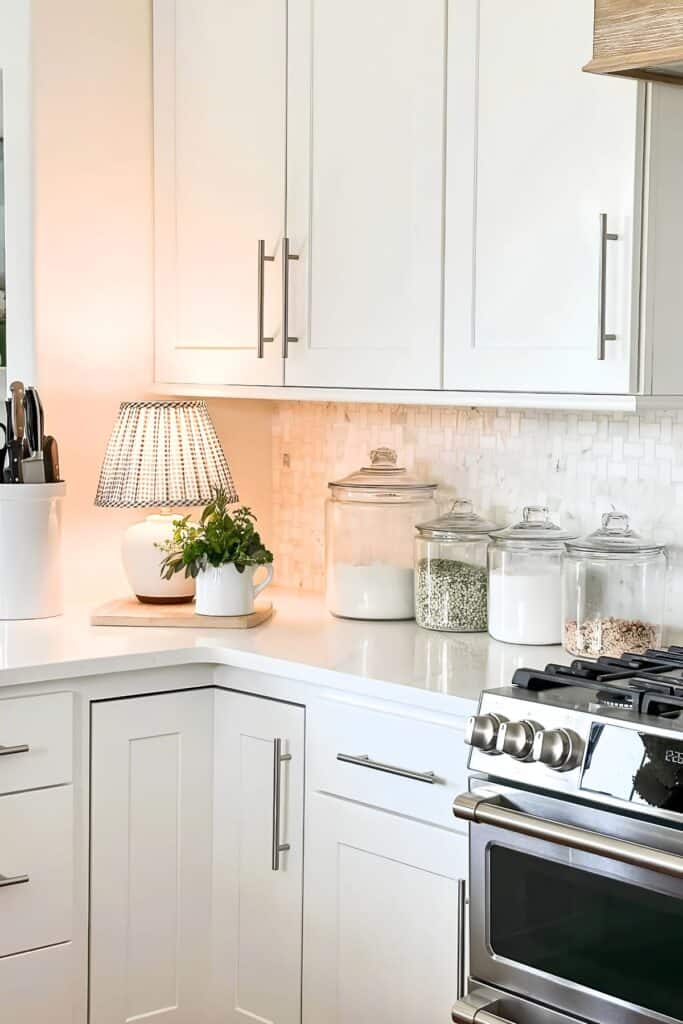 Small kitchen countertop lamp with a gingham shade adding ambient light near the stove