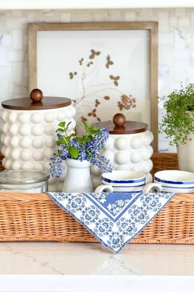 Kitchen coffee station decor with white hobnail canisters, spring lavender, and blue and white mugs