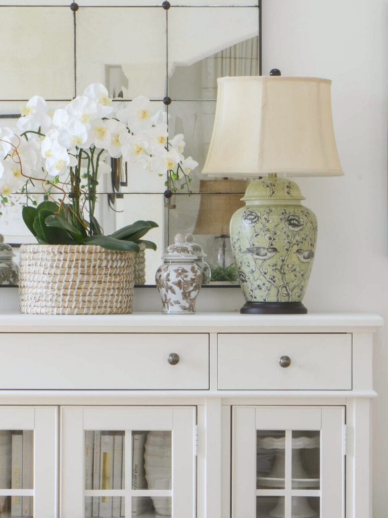 green ginger jar on a white buffet