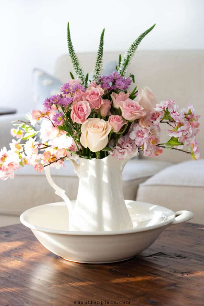 beautiful bouquet of spring flowers and roses in a pitcher