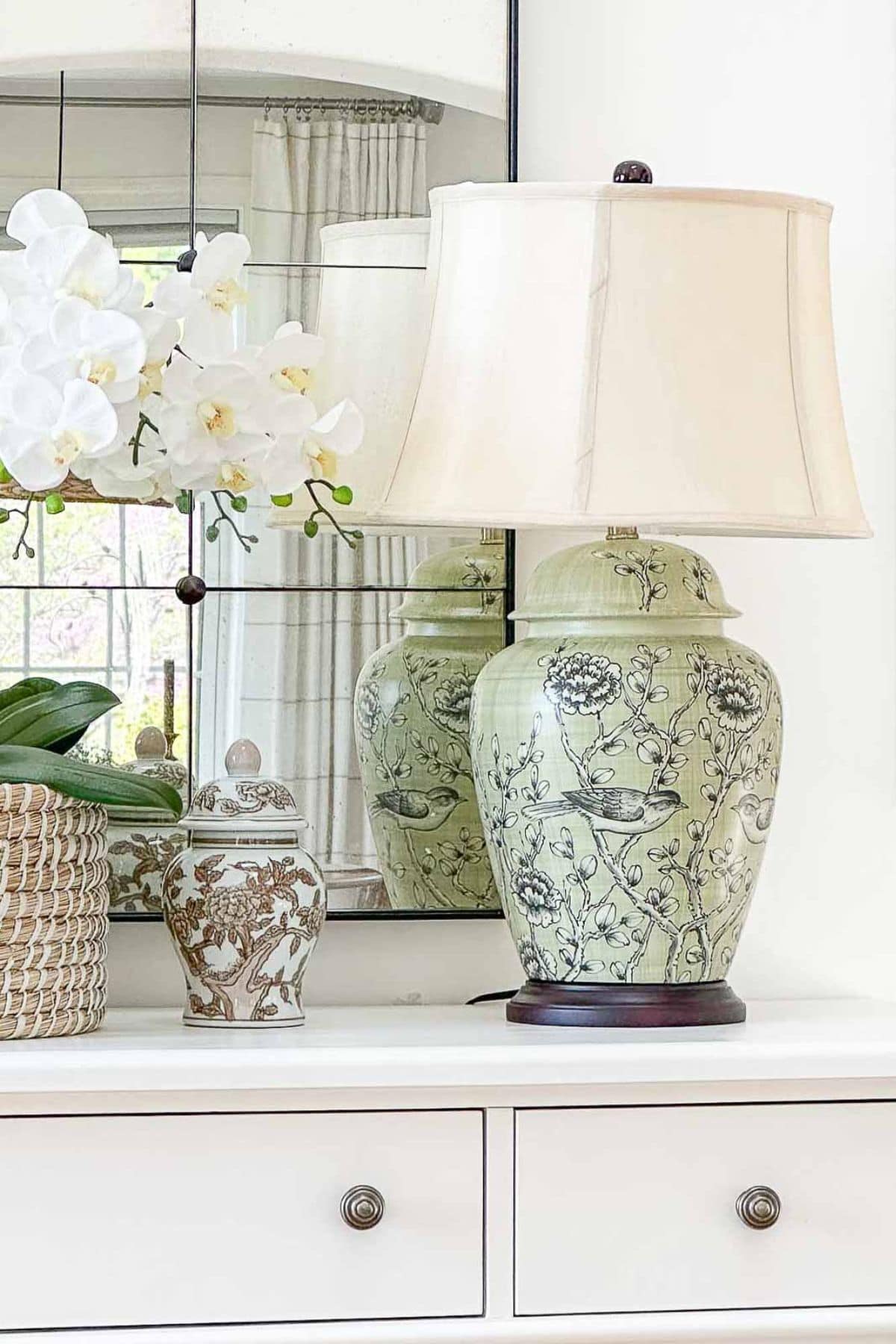 green ginger jar lamp on a white buffet