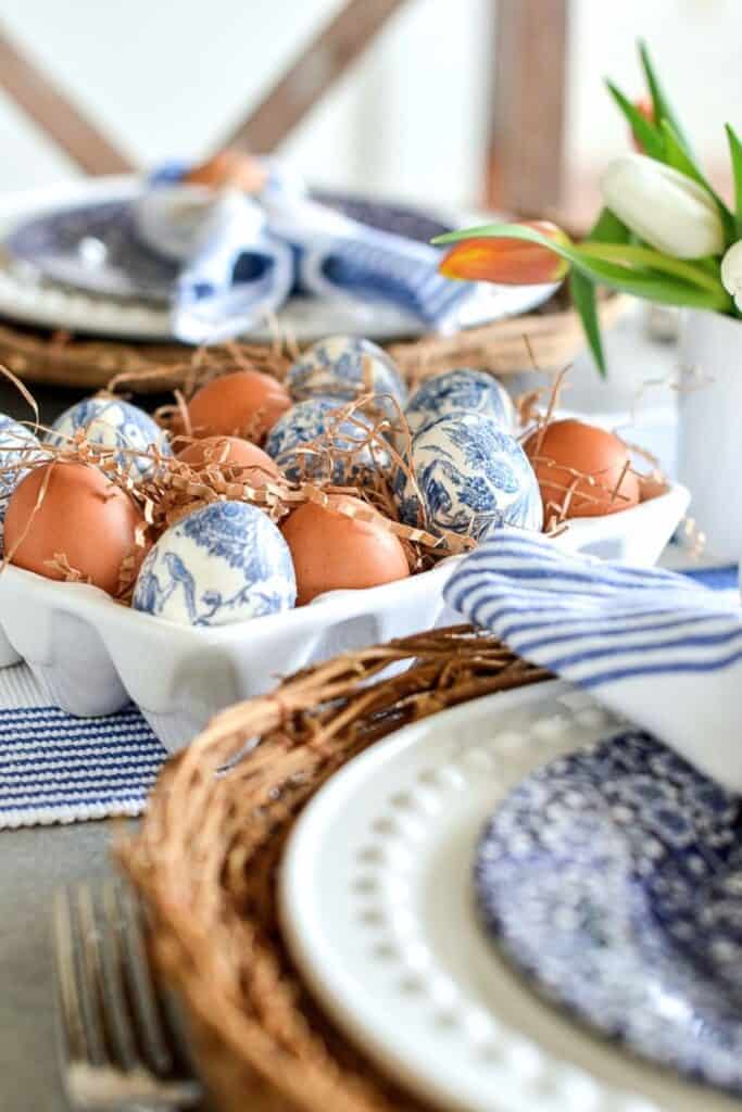 easy Easter table decorating ideas with eggs in a dish and blue and white table setting