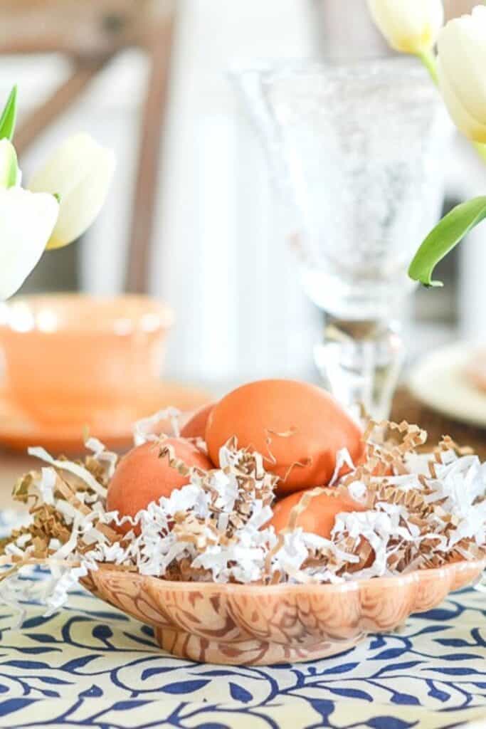 easy Easter table decorating ideas with tulips in glass vases and dyed eggs in a bowl