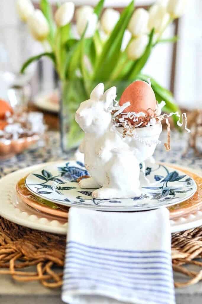 easy Easter table decorating ideas with bunny place setting and egg on layered plates