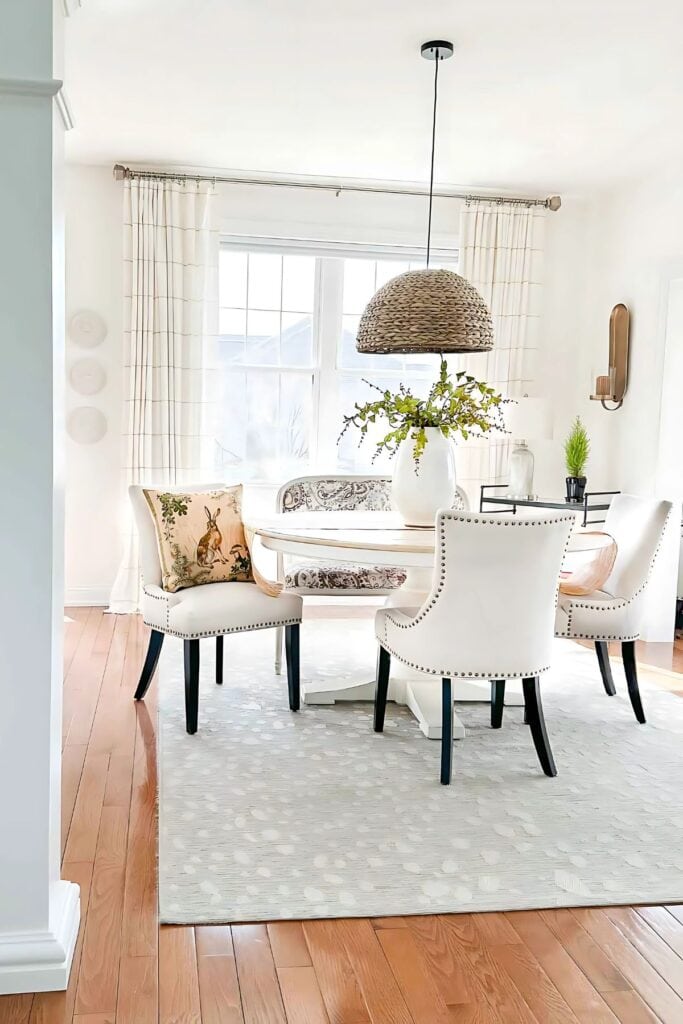 spring dining room- with a rabbit pillow in one chair