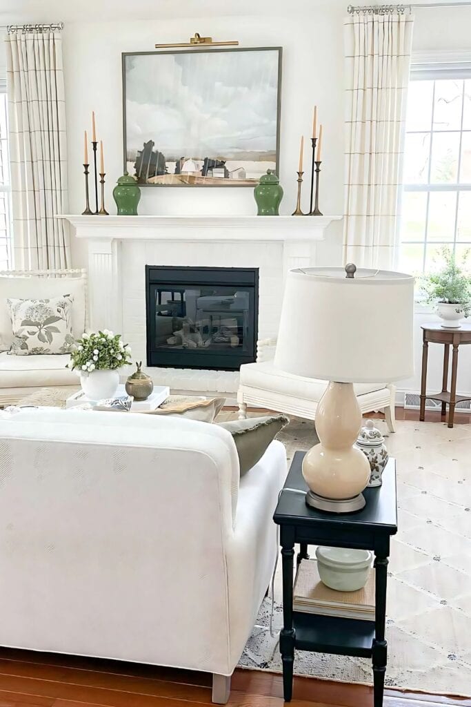 mantel with green ginger jars flanking a painting