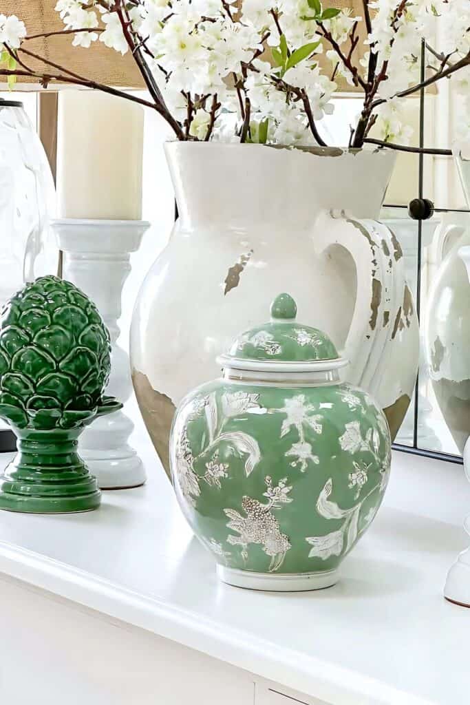 spring living room-green and white accent decor on the white buffet