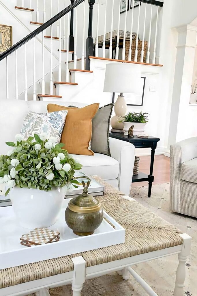 spring living room- sofa and coffee table with stairs in the background