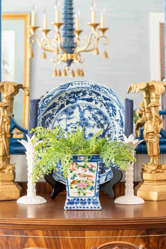 chinoiserie dishes and planter on a buffet