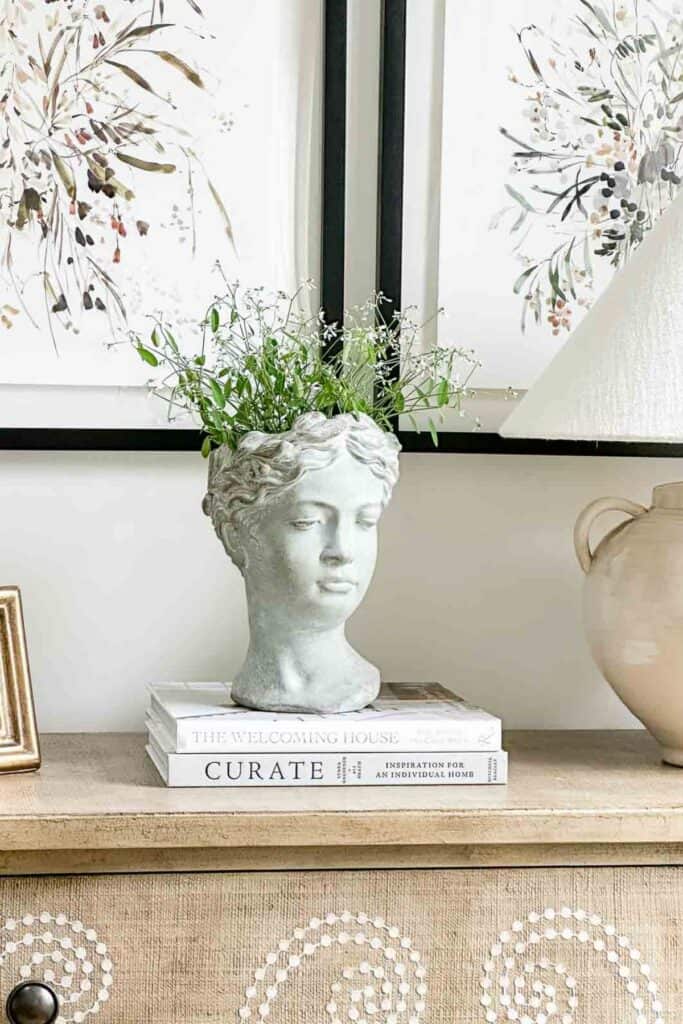decorative goddess planter head on a beige chest