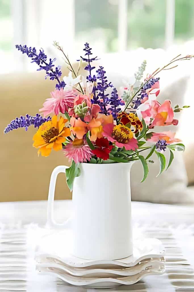 cut garden flowers in a white pitcher