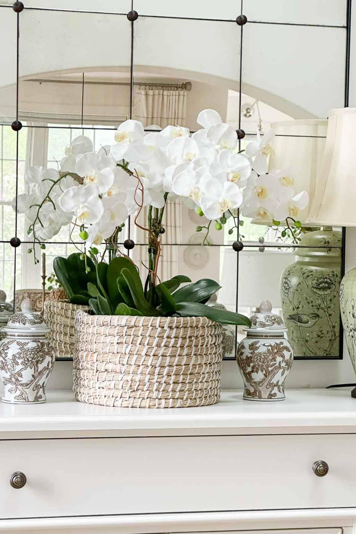 orchids in a basket on a buffet