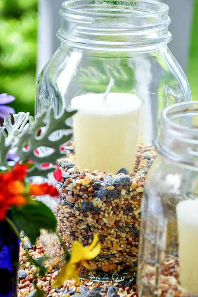 mason jar lanters filled with birdseed