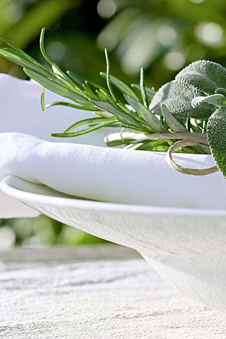 herbs and a white napkin on a bowl
