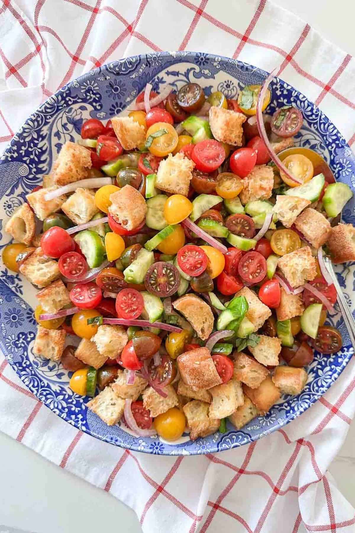 Panzanella salad in a blue and white bowl