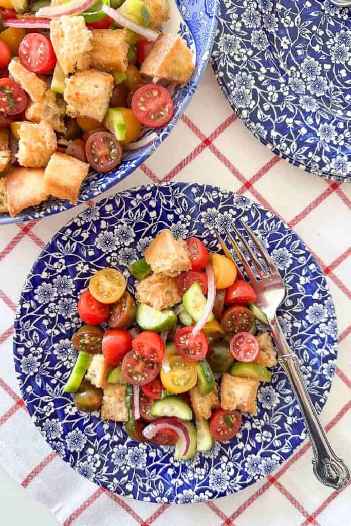 Panzanella salad on a blue and white plate