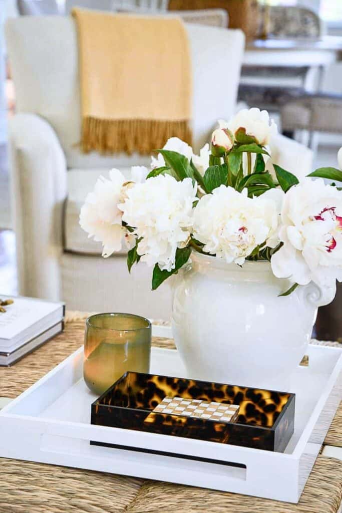vase of peonies on a coffee table
