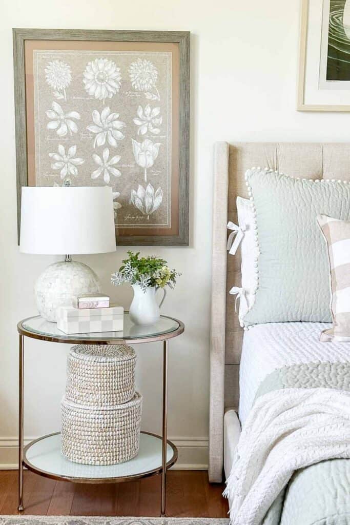 small round nightstand next to bed