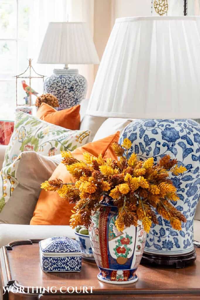 fall centerpiece and lamp on an end table