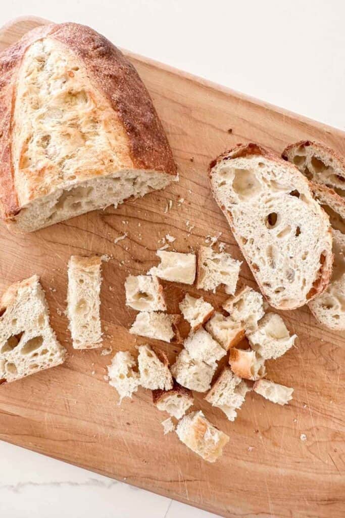 CRUSTY BREAD  on a wooden breadboard
