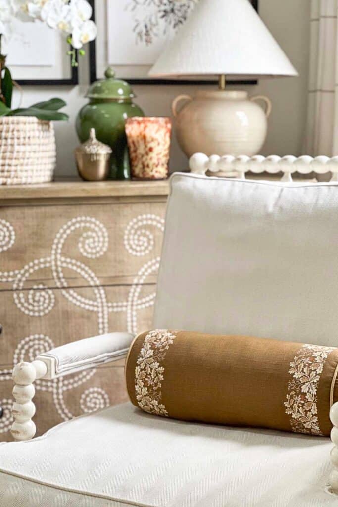 fall bolster pillow on a white spindle chair