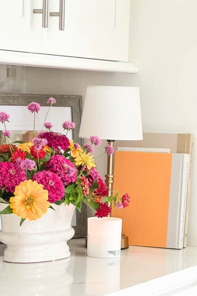 cookbooks on a counter leaning against a wall