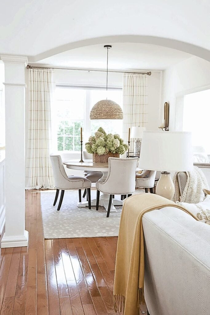 neutral dining room with warm wood floors and soft decor showing how to decorate with color and work with undertones