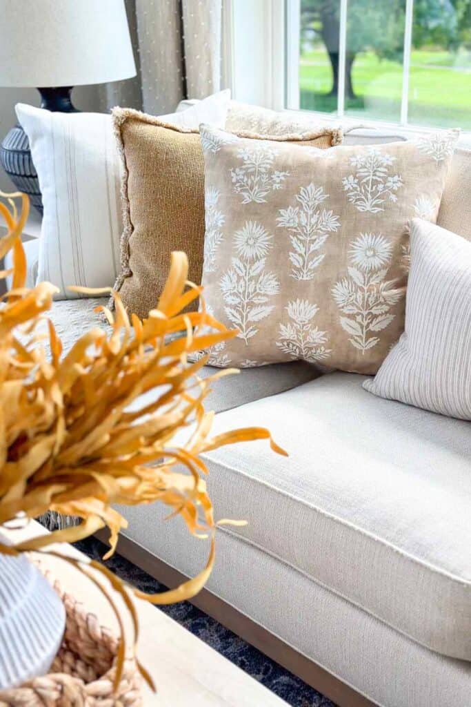 fall pillows in neutral colors on a sofa