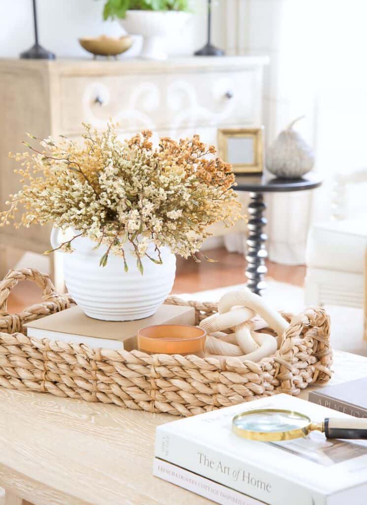 fall vignettte with a vase of dried yellow flowers and grasses