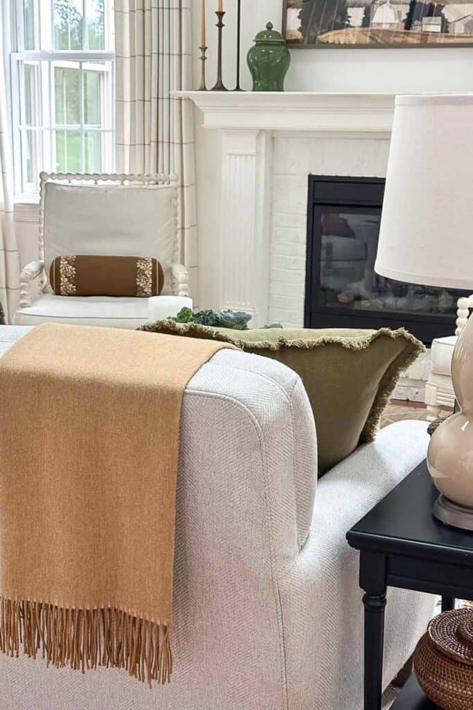 gold throw blanket over the back of a sofa